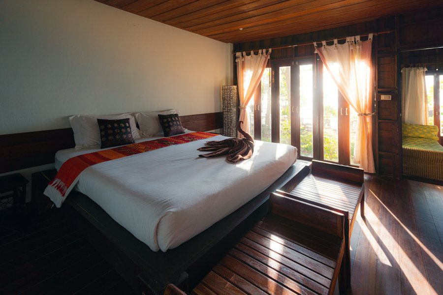 Comfortable room with a large bed and warm wooden ceiling