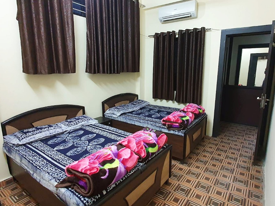 Large family room with two double beds and soft lighting